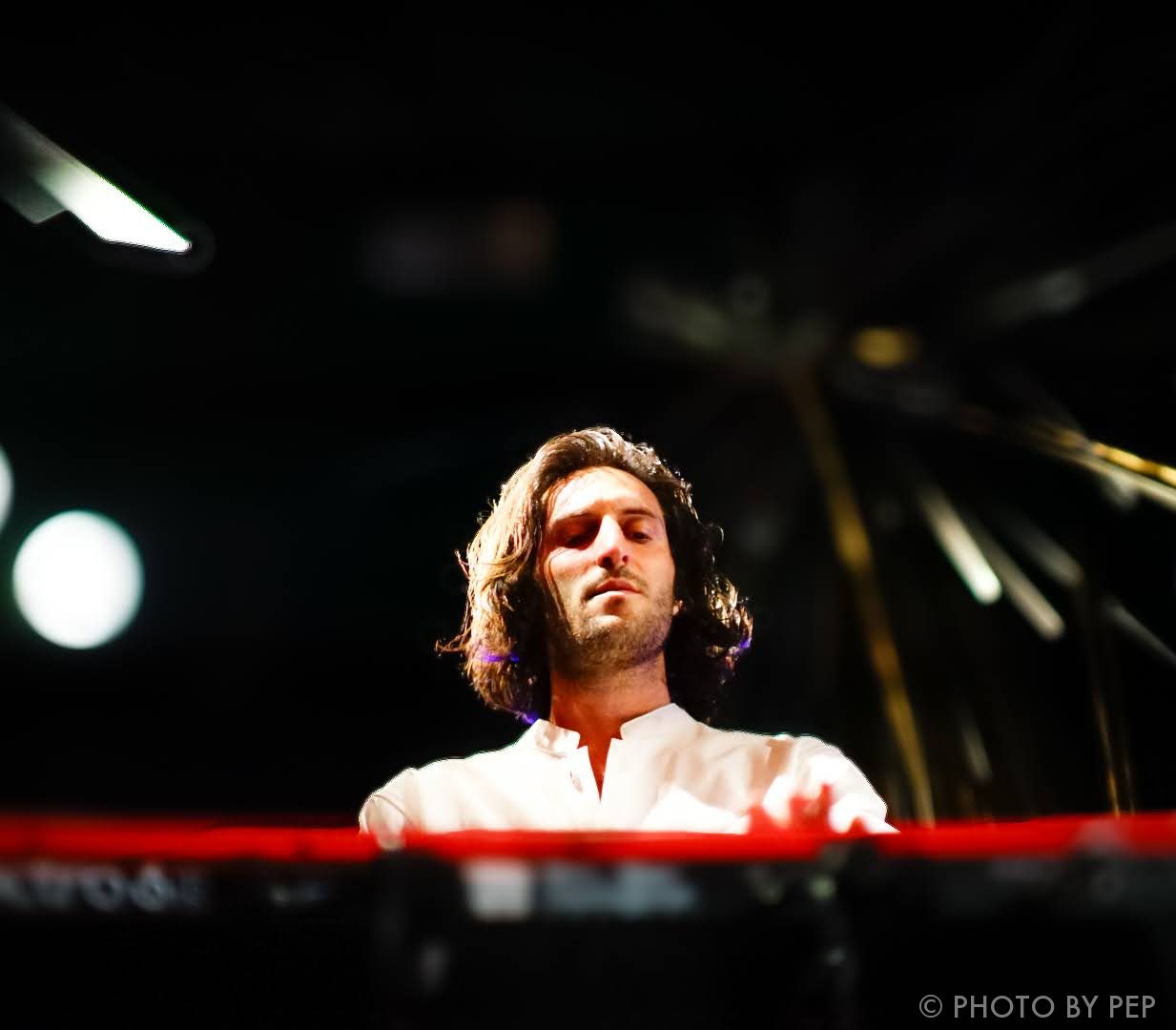Keyboardist in white shirt performing live